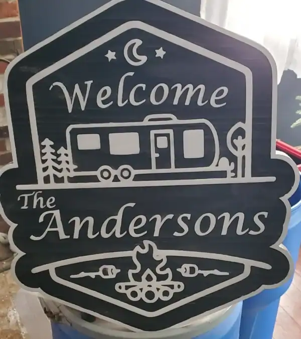 Custom camping sign with trailer, trees, moon, and campfire design for outdoor enthusiasts.