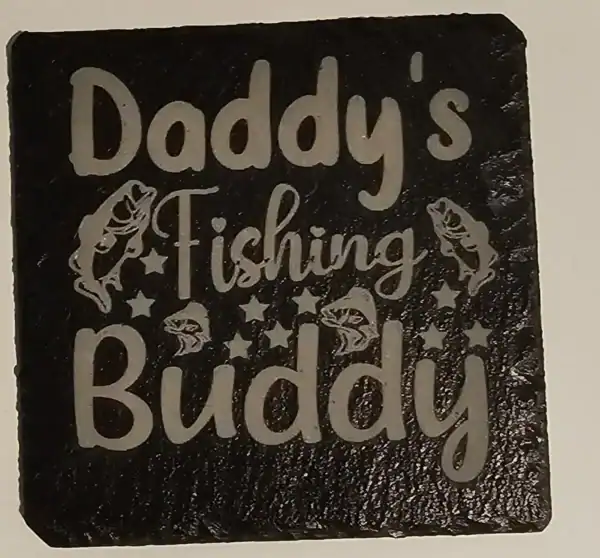 Laser-engraved slate coaster with "Daddy's Fishing Buddy" and small fish design.