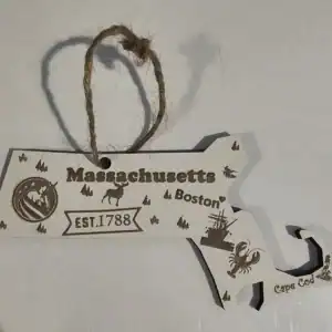 White Massachusetts state ornament with local symbols and landmarks.