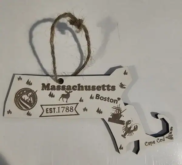 White Massachusetts state ornament with local symbols and landmarks.