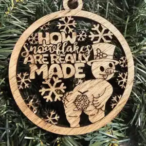 Wooden snowflake ornament with snowman and humorous "Ho Ho Ho" message for holiday decor.