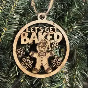 Wooden gingerbread ornament with "Let's Get Baked" text and snowflake designs, perfect for holiday d.