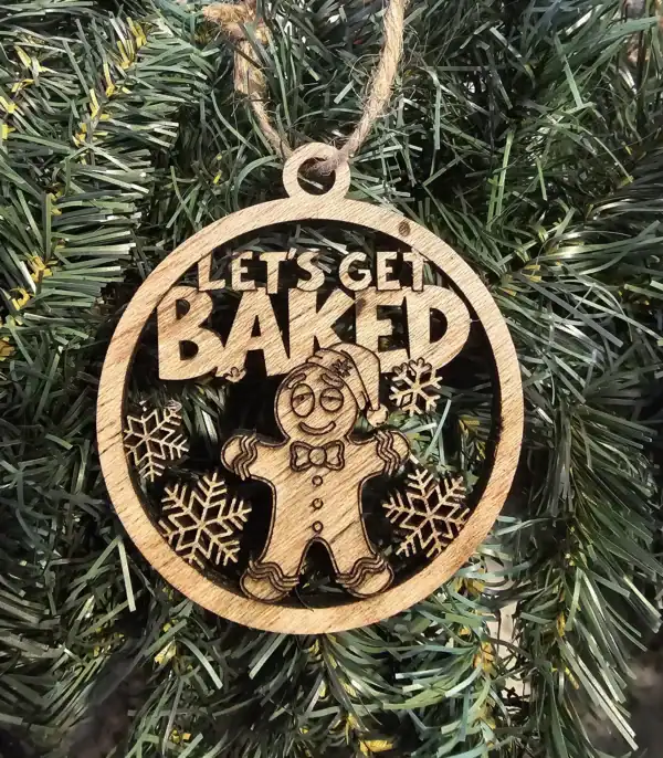 Wooden gingerbread ornament with "Let's Get Baked" text and snowflake designs, perfect for holiday d.