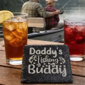 Engraved slate coaster with "Daddy's Fishing Buddy" design, perfect for fishing enthusiasts.