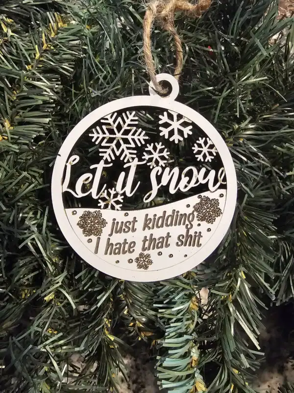 Ornament with snowflakes and humorous quote for holiday decor.