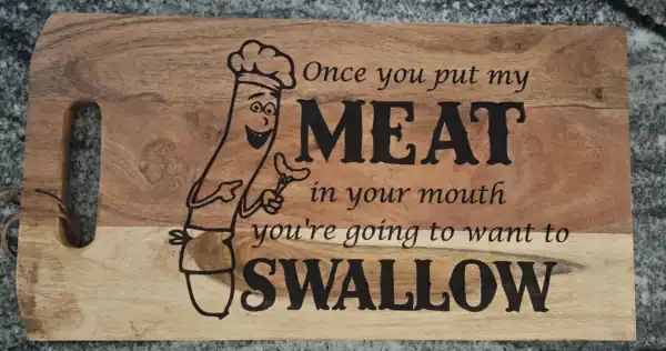 Humorous meat swallow design on wooden cutting board for kitchen decor and gifts.