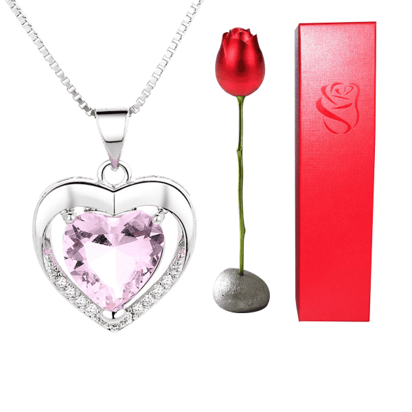Stunning silver heart-shaped pendant with pink gemstone and diamond accents, perfect for special occasions.