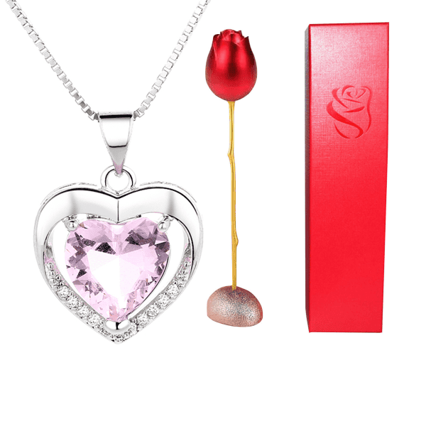 Elegant silver heart-shaped pendant with pink gemstone and diamond accents, perfect for gifts.