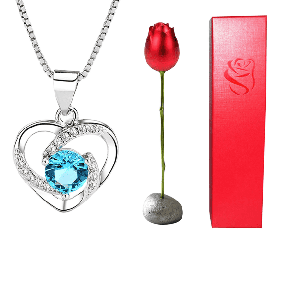 Elegant silver heart pendant with crystals and blue gemstone, perfect for gifts and jewelry lovers.